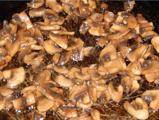 Выкладываем грибы к луку и жарим до готовности