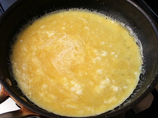 Тонкий омлет с сыром и помидорами на сковороде